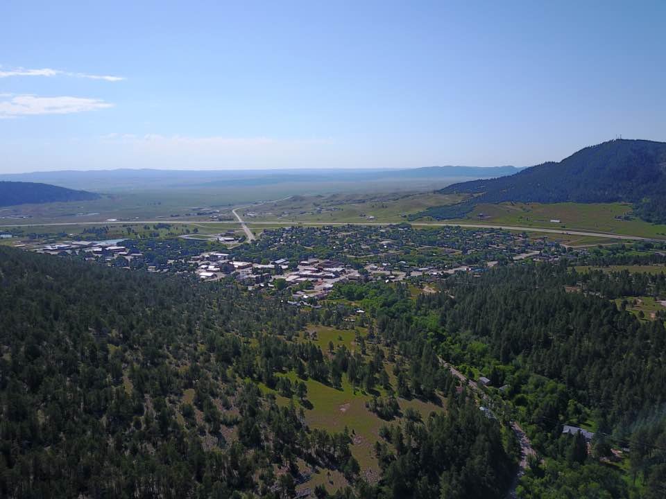 Aerial photo of Sundance, Wyoming, a town in a forested valley