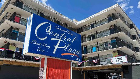 Downtown Central Plaza sign in front of large building